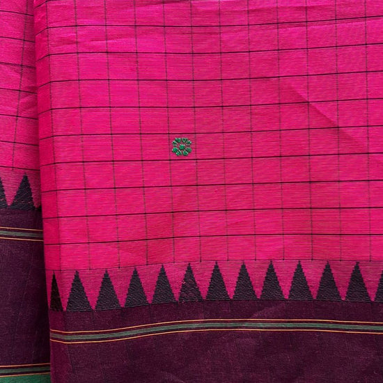 Pink and green saree with a visible brand logo on a neutral background